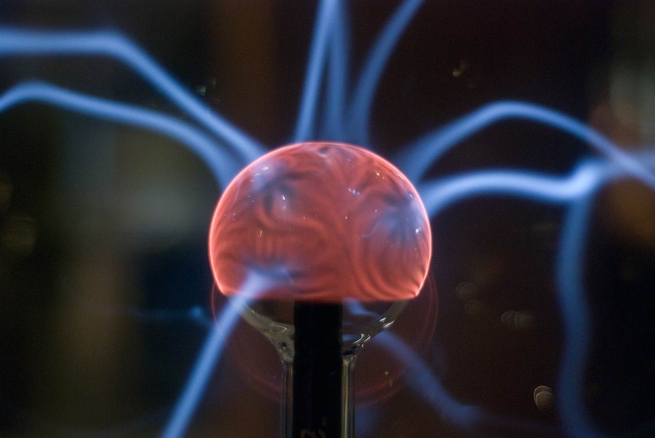 Plasma ball with energy rays on dark background