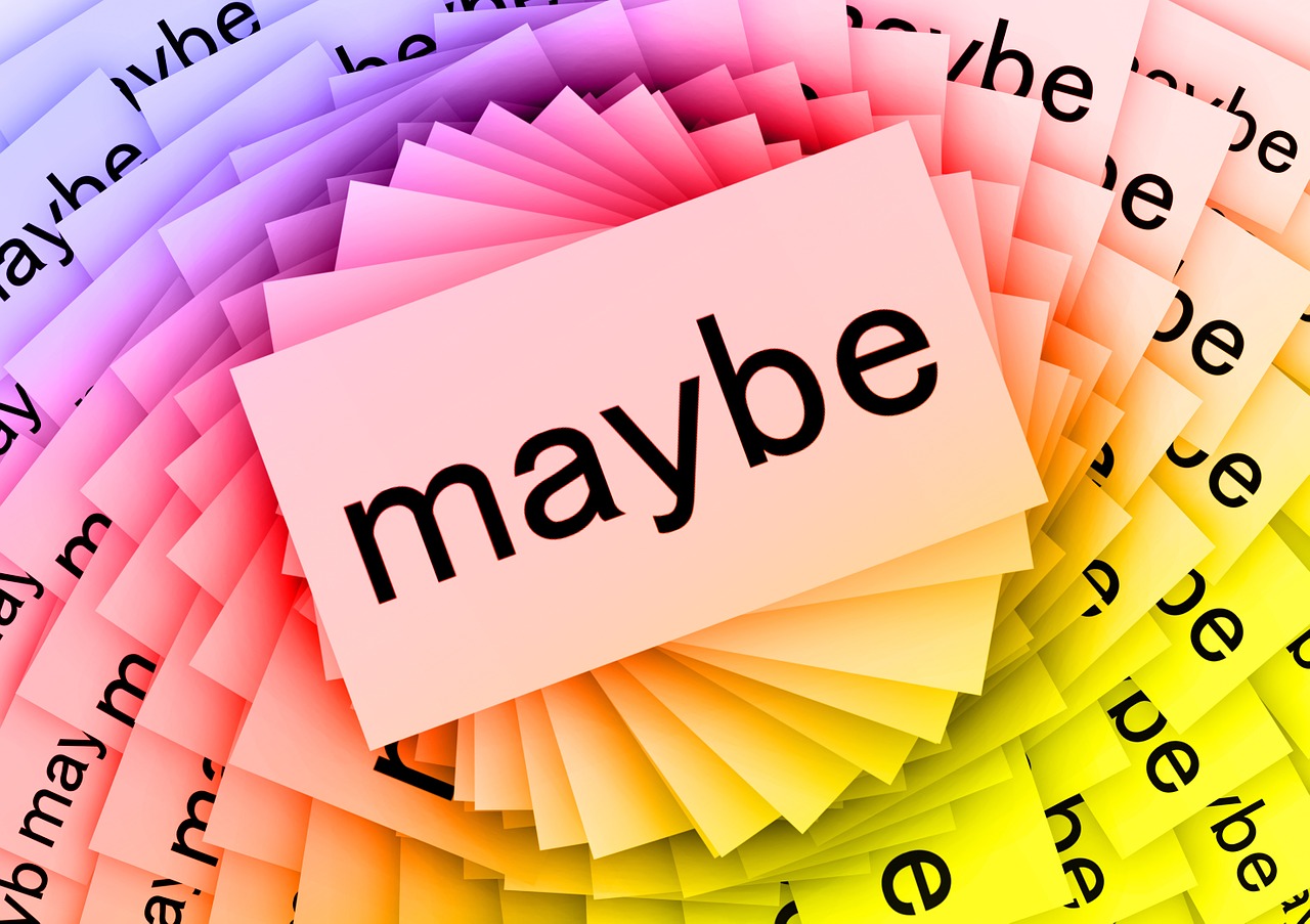 Multicolored paper with the word 'maybe' written all over them