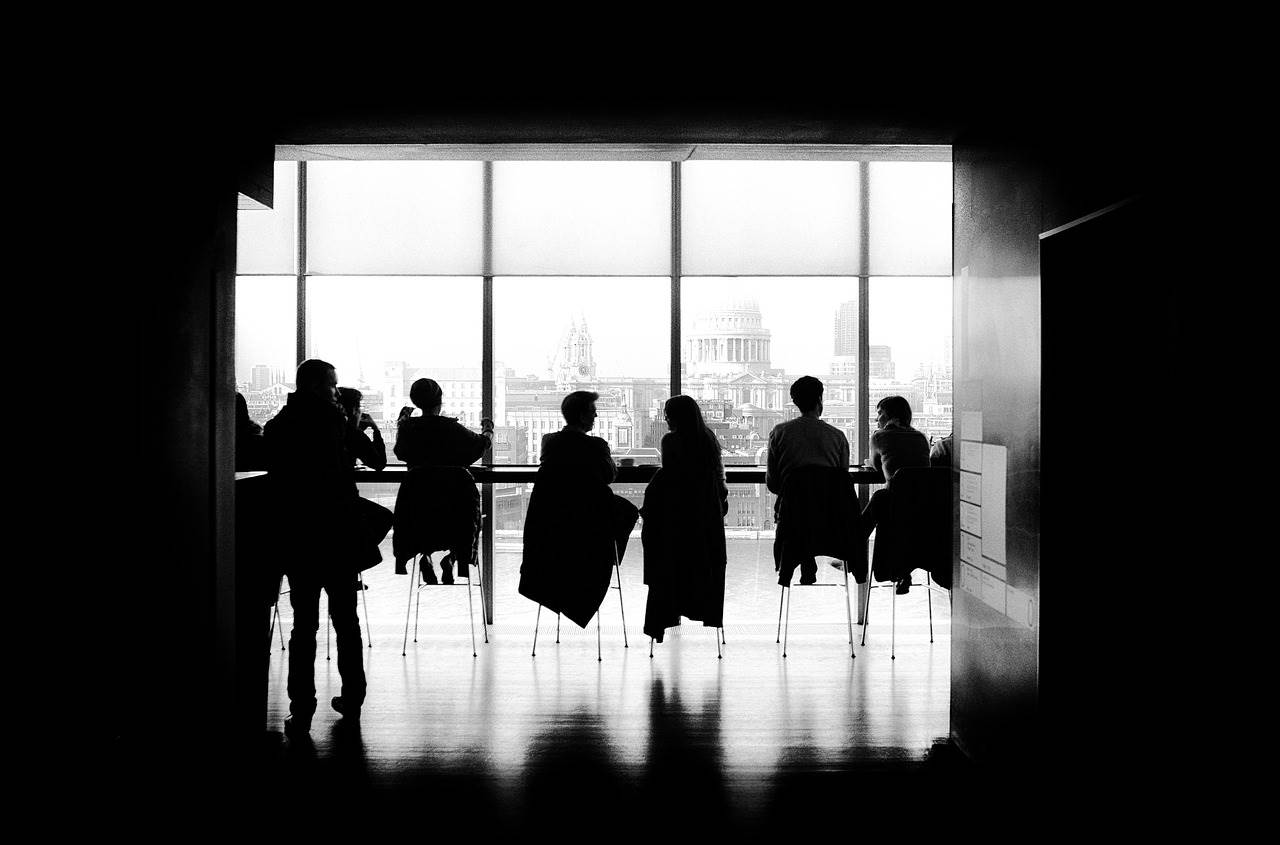 People chatting with the London skyline in the background