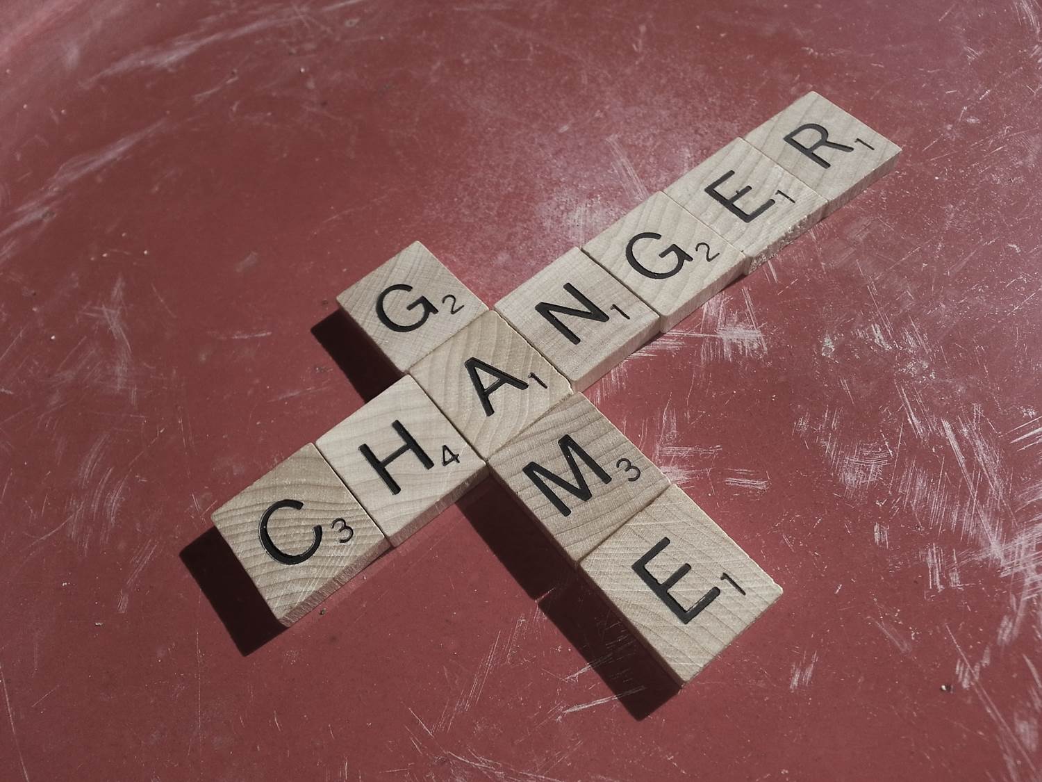 Scrabble letters spelling out 'game changer'