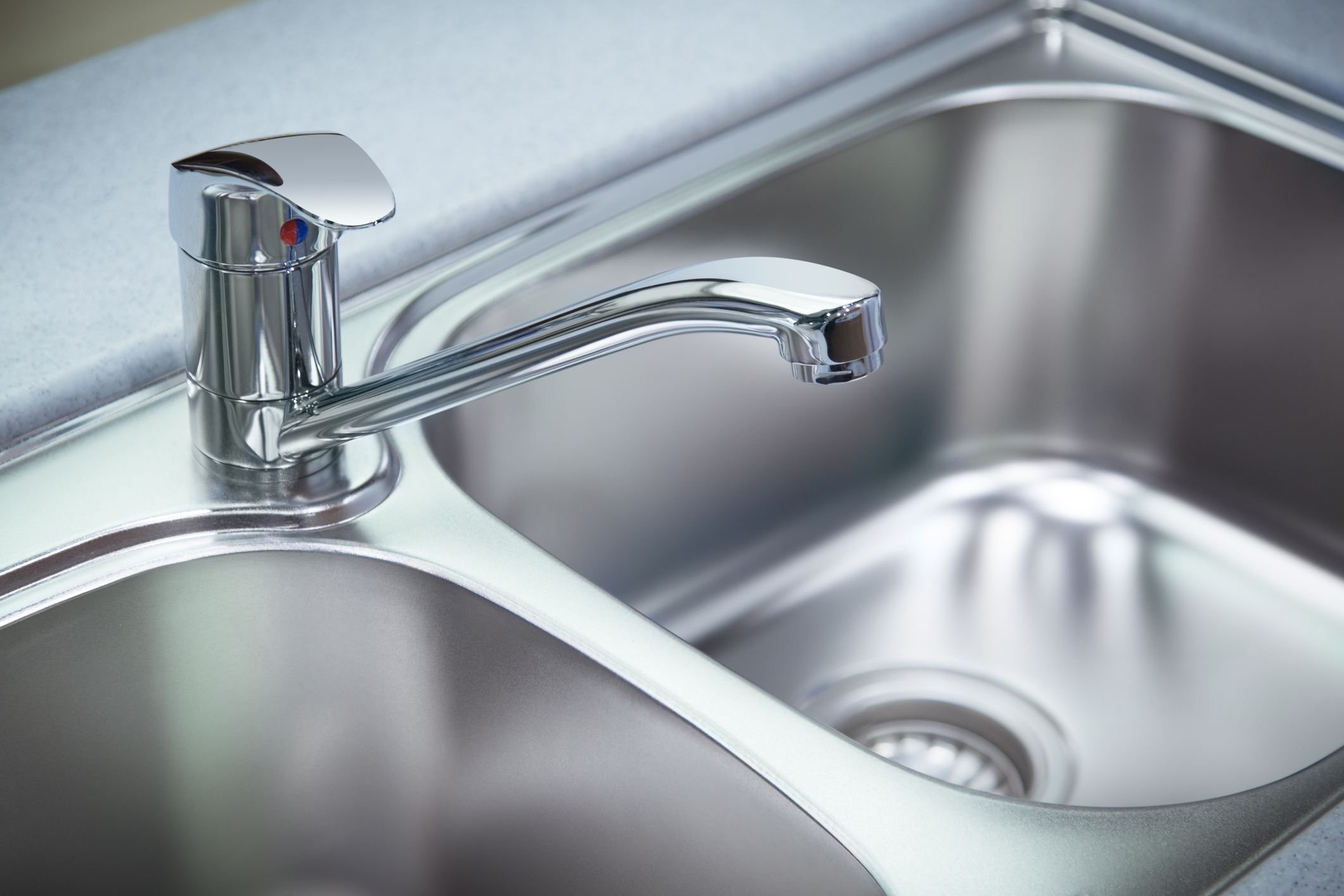 Kitchen sink with tap in focus