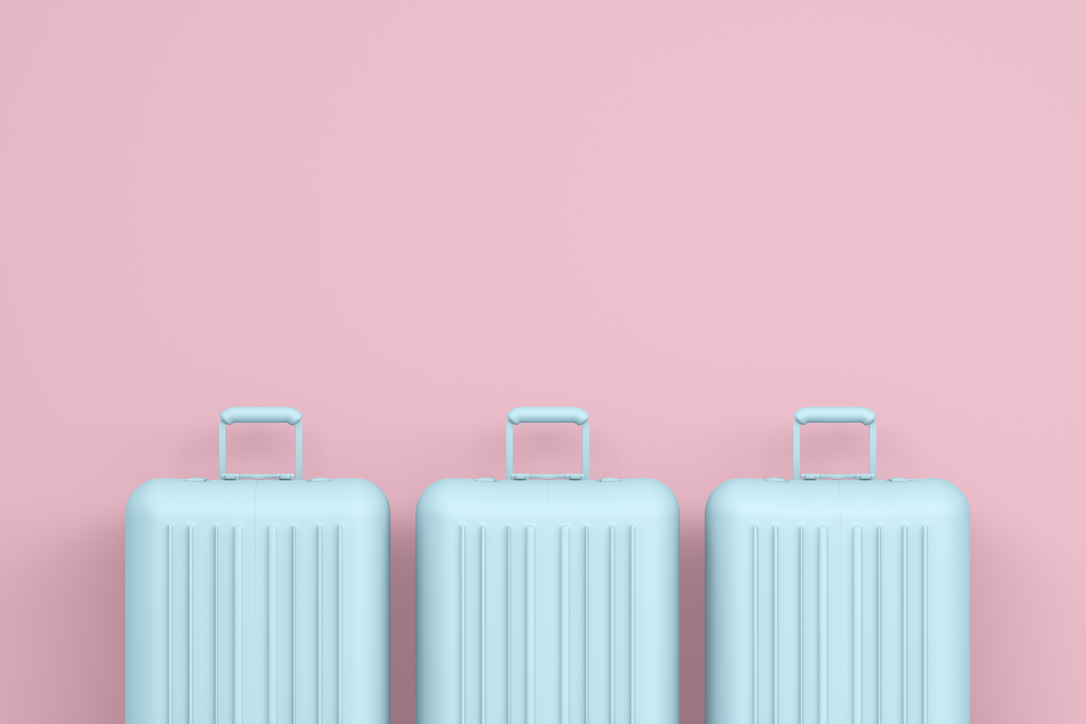 Blue suitcases in a pink room