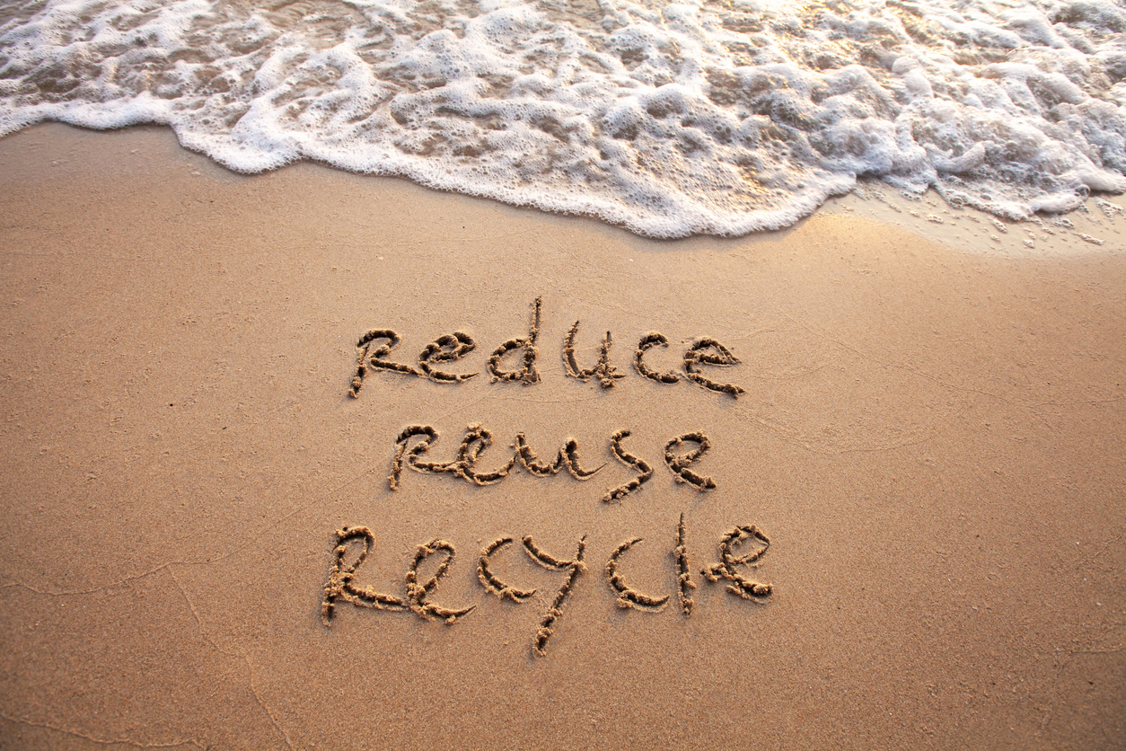 Reduce, Reuse, Recycle written in sand