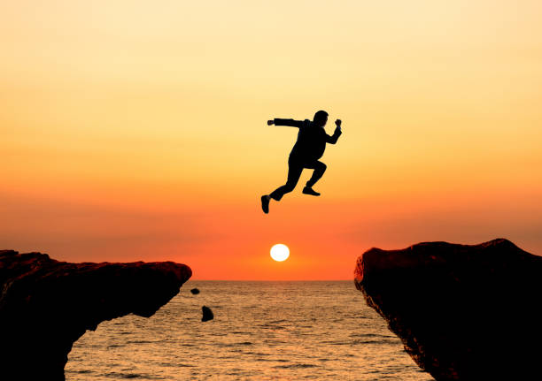 Leap of faith in front of ocean