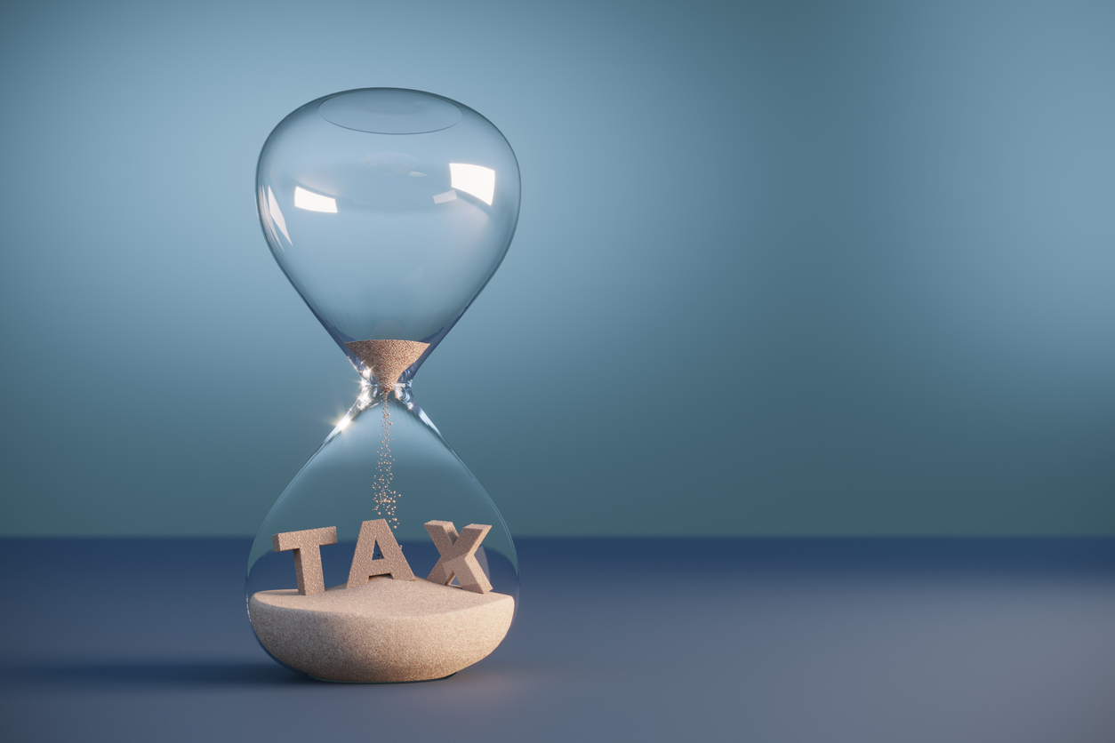 Hourglass with sand spelling 'tax'