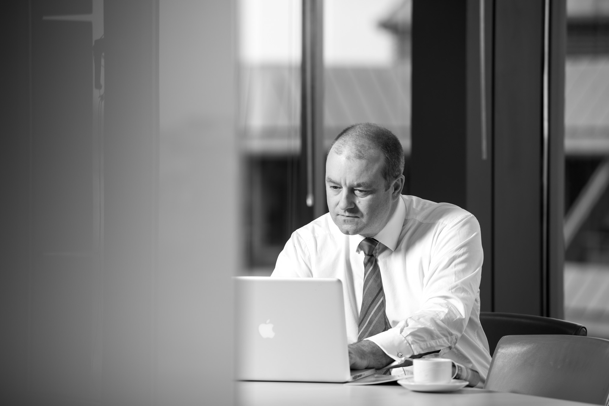 Andy Drane working on laptop at Davidson Chalmers Stewart